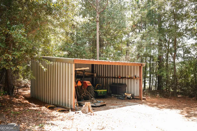 a kitchen with stainless steel appliances granite countertop a refrigerator a stove and white cabinets with wooden floor