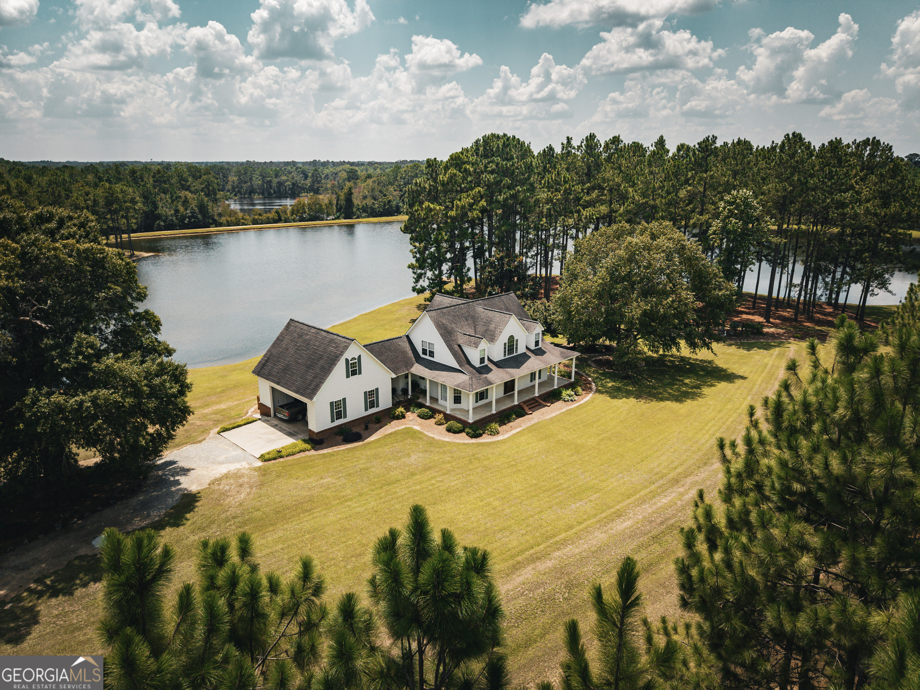 1576 Chula Brookfield Road Tifton, GA 31794 - Photo 65 of 79 a view of a lake with a trees in the background