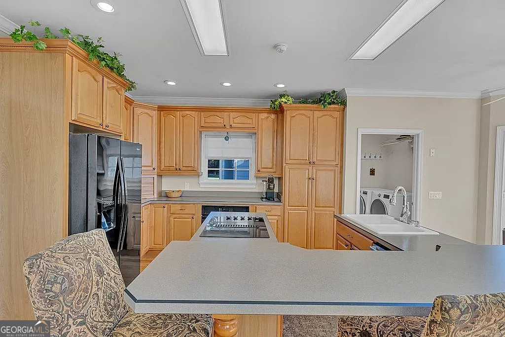 1576 Chula Brookfield Road Tifton, GA 31794 - Photo 67 of 79 a kitchen with stainless steel appliances granite countertop a refrigerator a stove and white cabinets with wooden floor