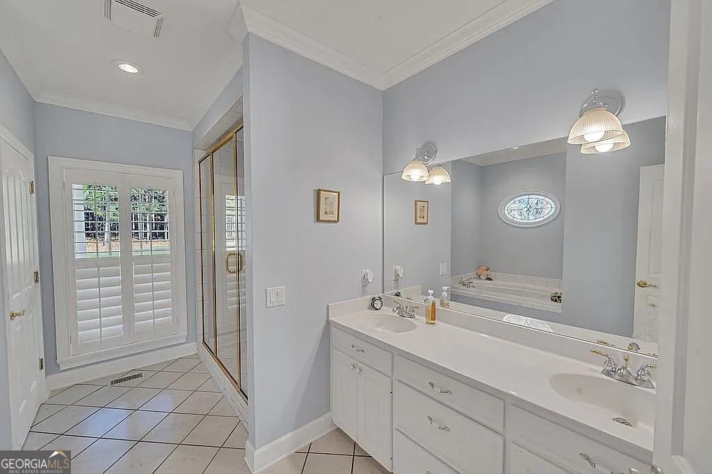 1576 Chula Brookfield Road Tifton, GA 31794 - Photo 73 of 79 a bathroom with a double vanity sink and a mirror