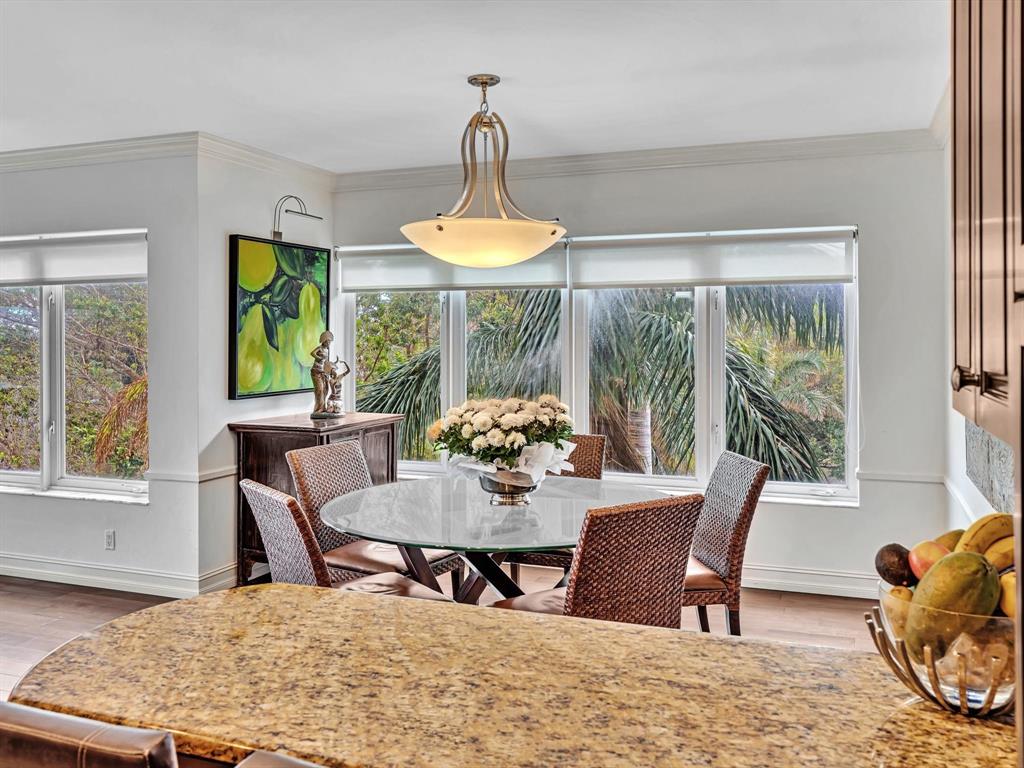 701 East Camino Real, Unit 4E Boca Raton, FL 33432 - Photo 18 of 45 a dining room with furniture a chandelier and wooden floor