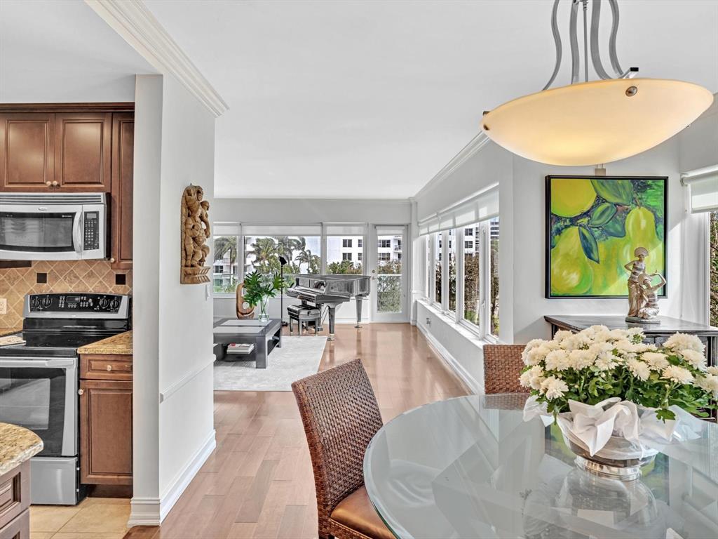 701 East Camino Real, Unit 4E Boca Raton, FL 33432 - Photo 20 of 45 a dining room with furniture entryway and wooden floor