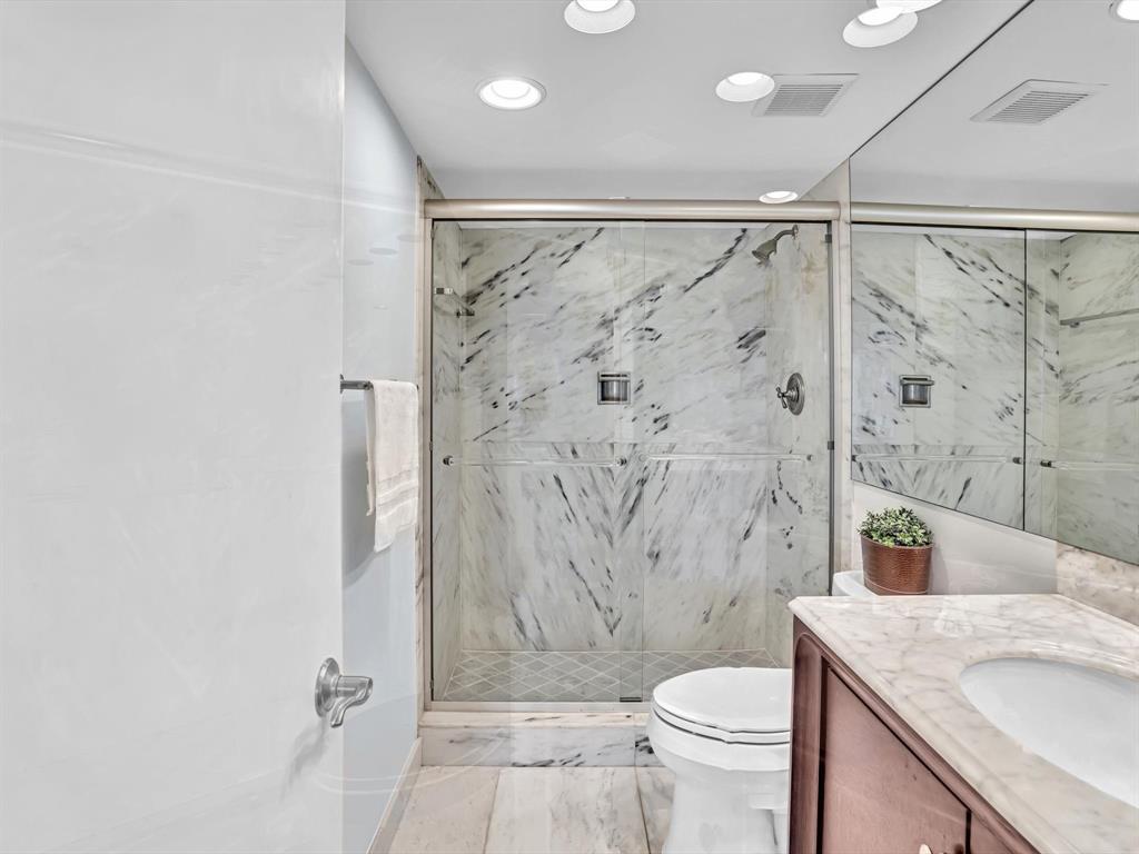 701 East Camino Real, Unit 4E Boca Raton, FL 33432 - Photo 24 of 45 a bathroom with a sink toilet and shower