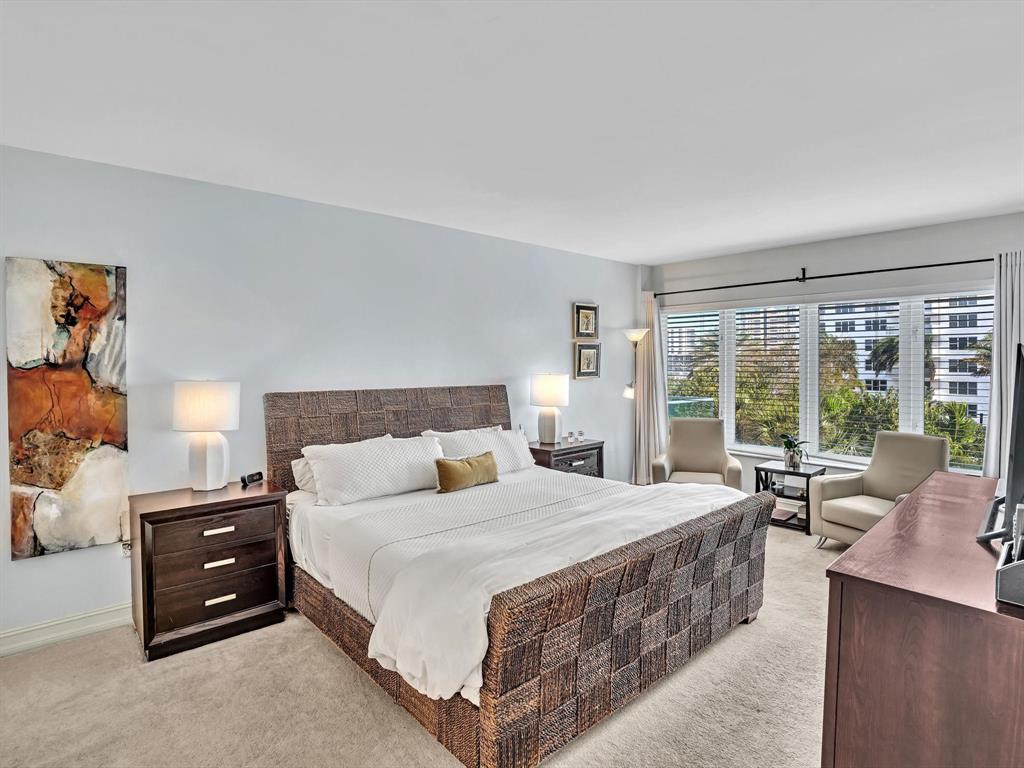 701 East Camino Real, Unit 4E Boca Raton, FL 33432 - Photo 27 of 45 a bedroom with a bed and large windows