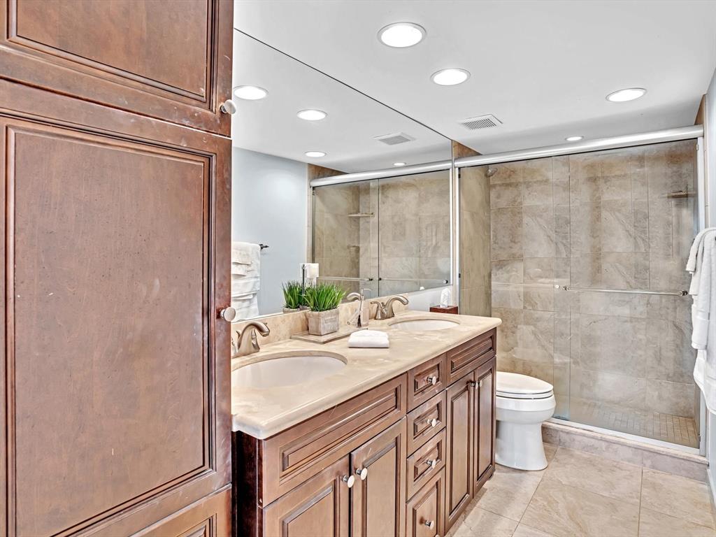 701 East Camino Real, Unit 4E Boca Raton, FL 33432 - Photo 28 of 45 a bathroom with a sink a toilet and shower