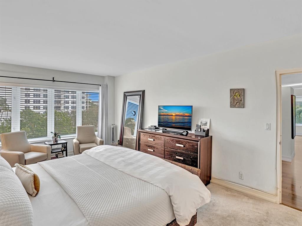 701 East Camino Real, Unit 4E Boca Raton, FL 33432 - Photo 29 of 45 a bedroom with a bed and large windows