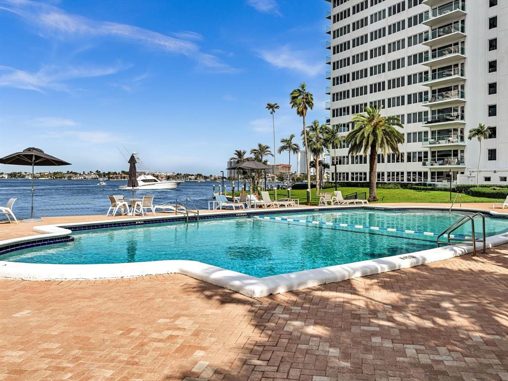 701 East Camino Real, Unit 4E Boca Raton, FL 33432 - Photo 37 of 45 a view of a swimming pool with a yard