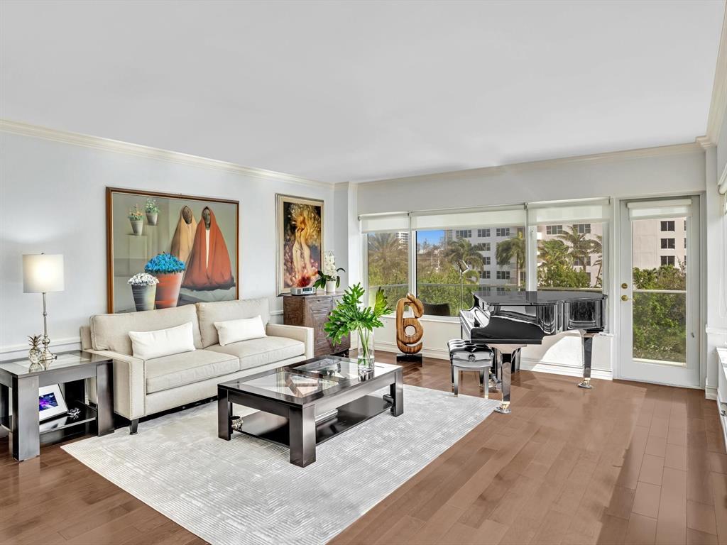 701 East Camino Real, Unit 4E Boca Raton, FL 33432 - Photo 10 of 45 a living room with furniture large window and a table