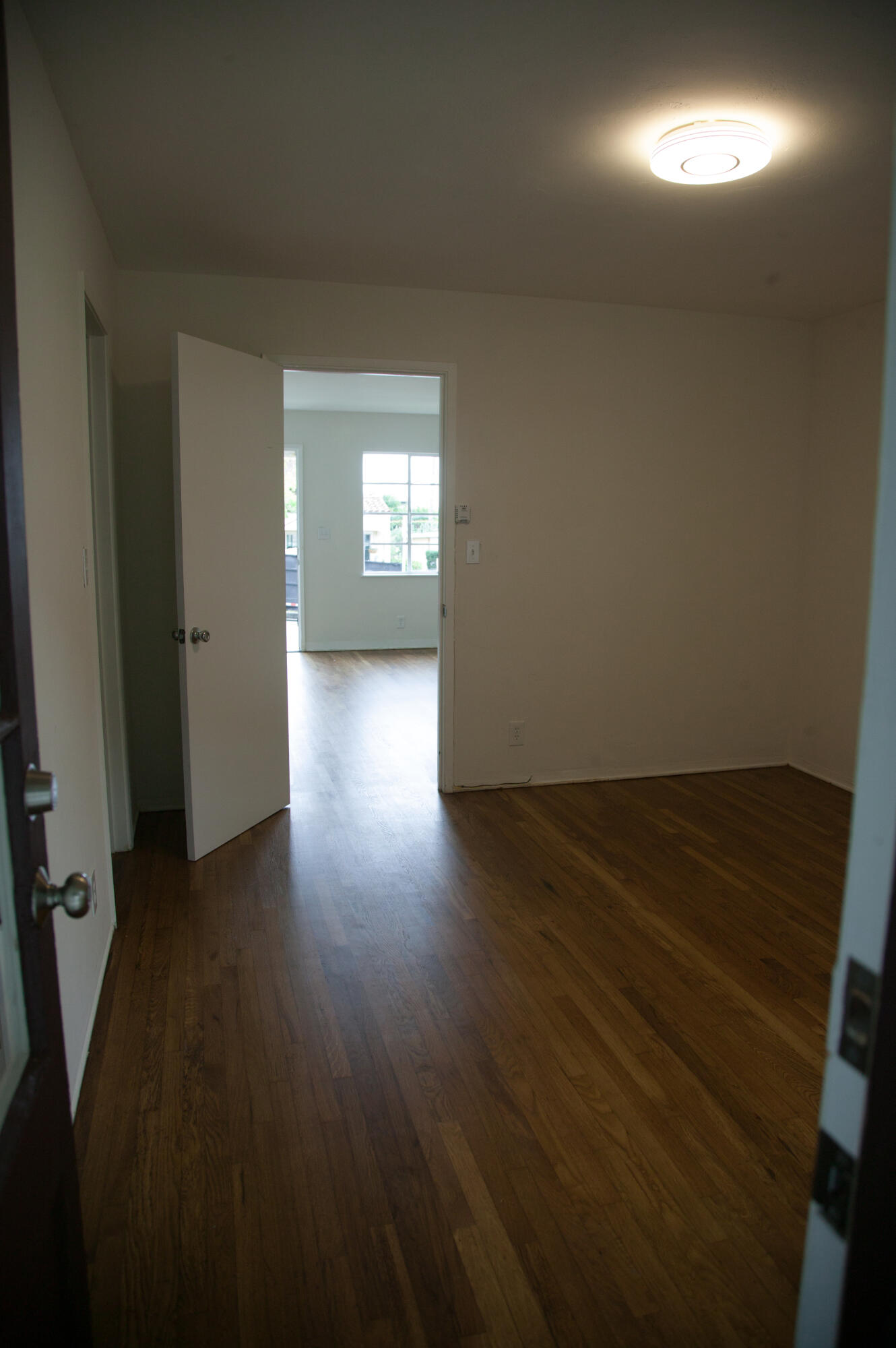 815 East Figueroa Street Santa Barbara, CA 93103 - Photo 12 of 17 an empty room with wooden floor and windows