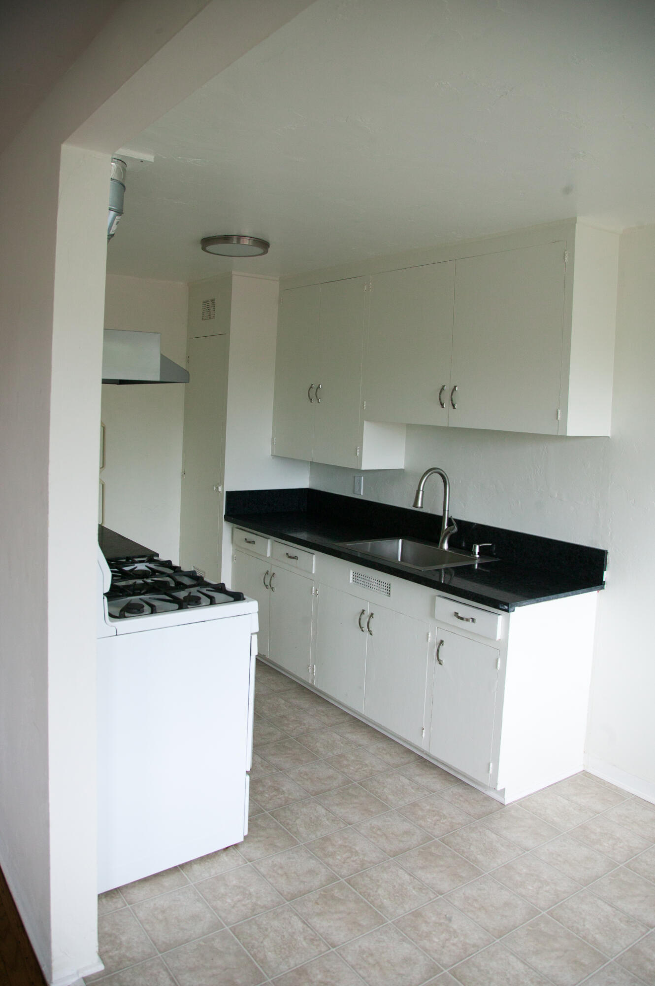 815 East Figueroa Street Santa Barbara, CA 93103 - Photo 6 of 17 a kitchen with granite countertop a stove and a sink