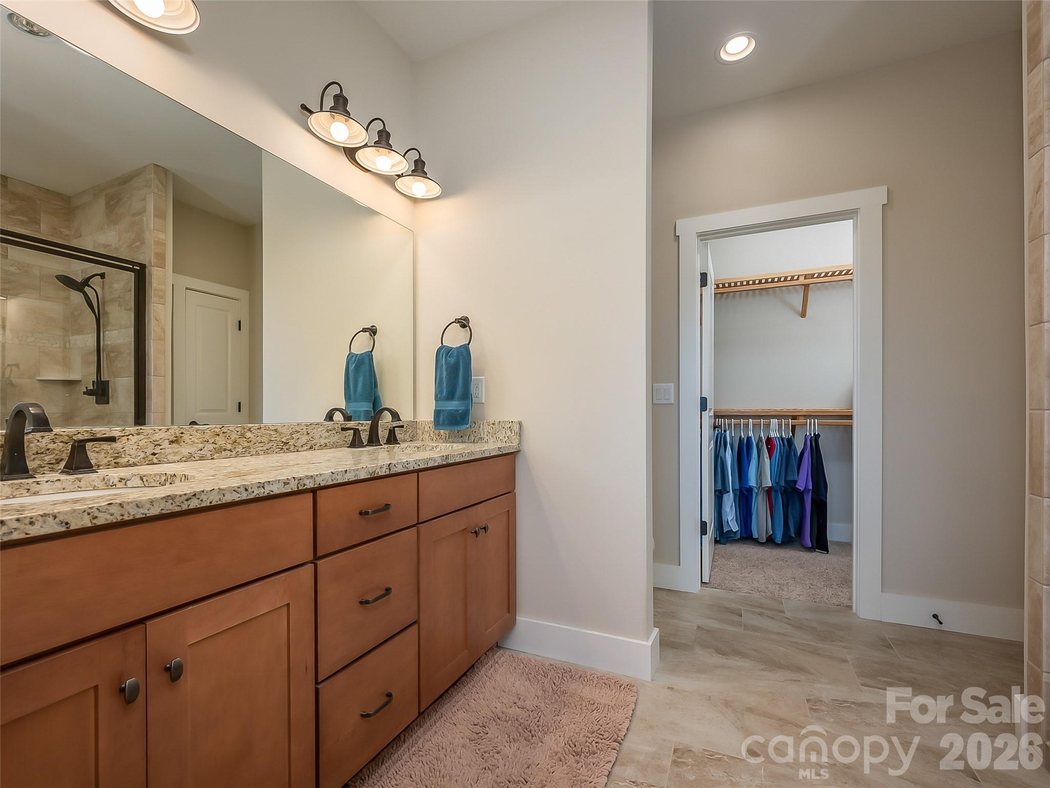 146 Red Hawk Knoll Lake Lure, NC 28746 - Photo 18 of 34 a bathroom with a granite countertop sink and a mirror