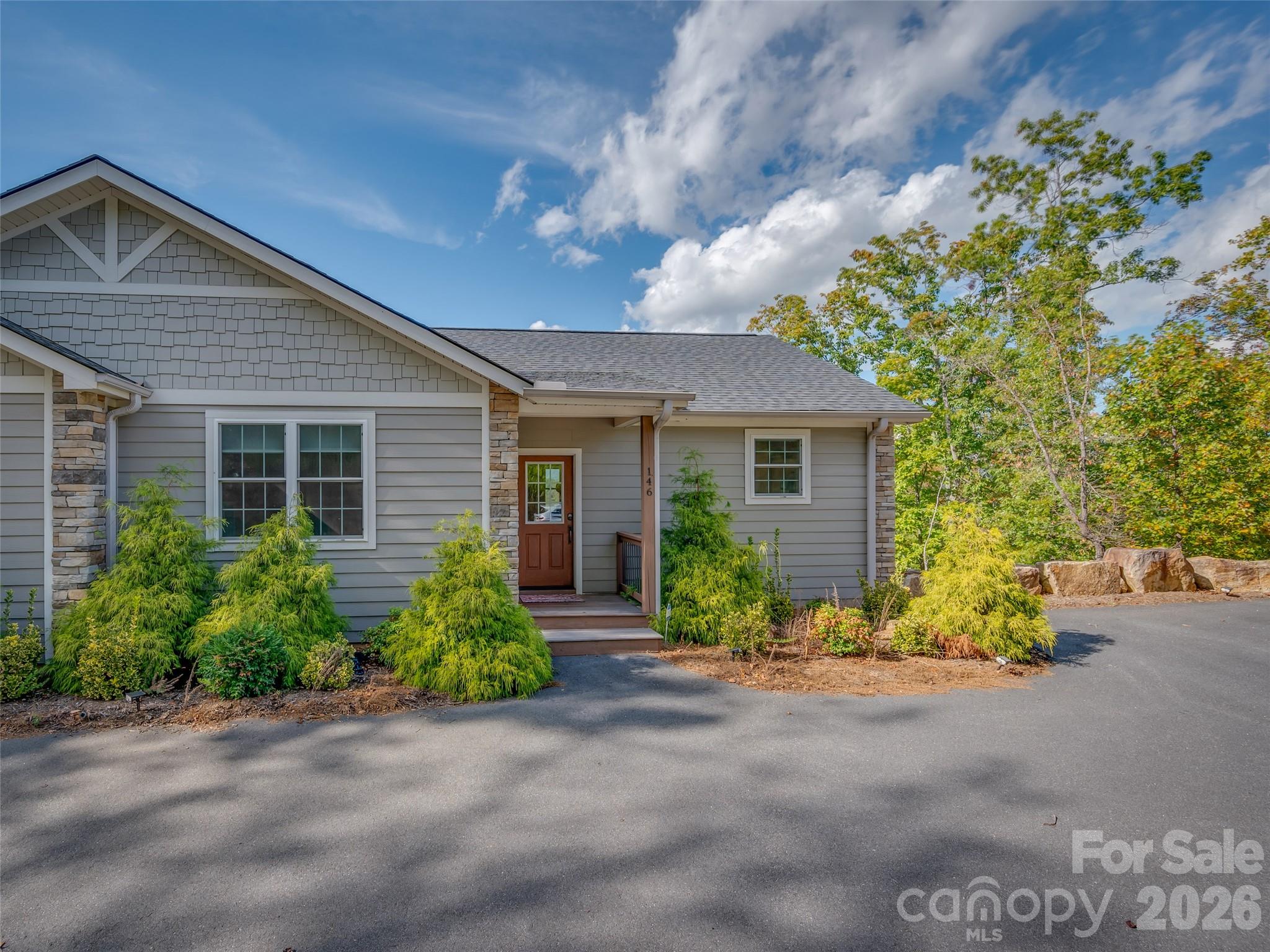 146 Red Hawk Knoll Lake Lure, NC 28746 - Photo 2 of 34 a front view of a house with a yard and potted plants