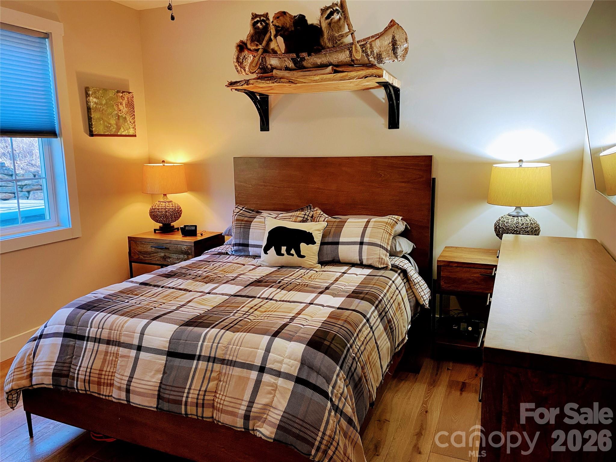 146 Red Hawk Knoll Lake Lure, NC 28746 - Photo 24 of 34 a bedroom with a bed and wooden floor