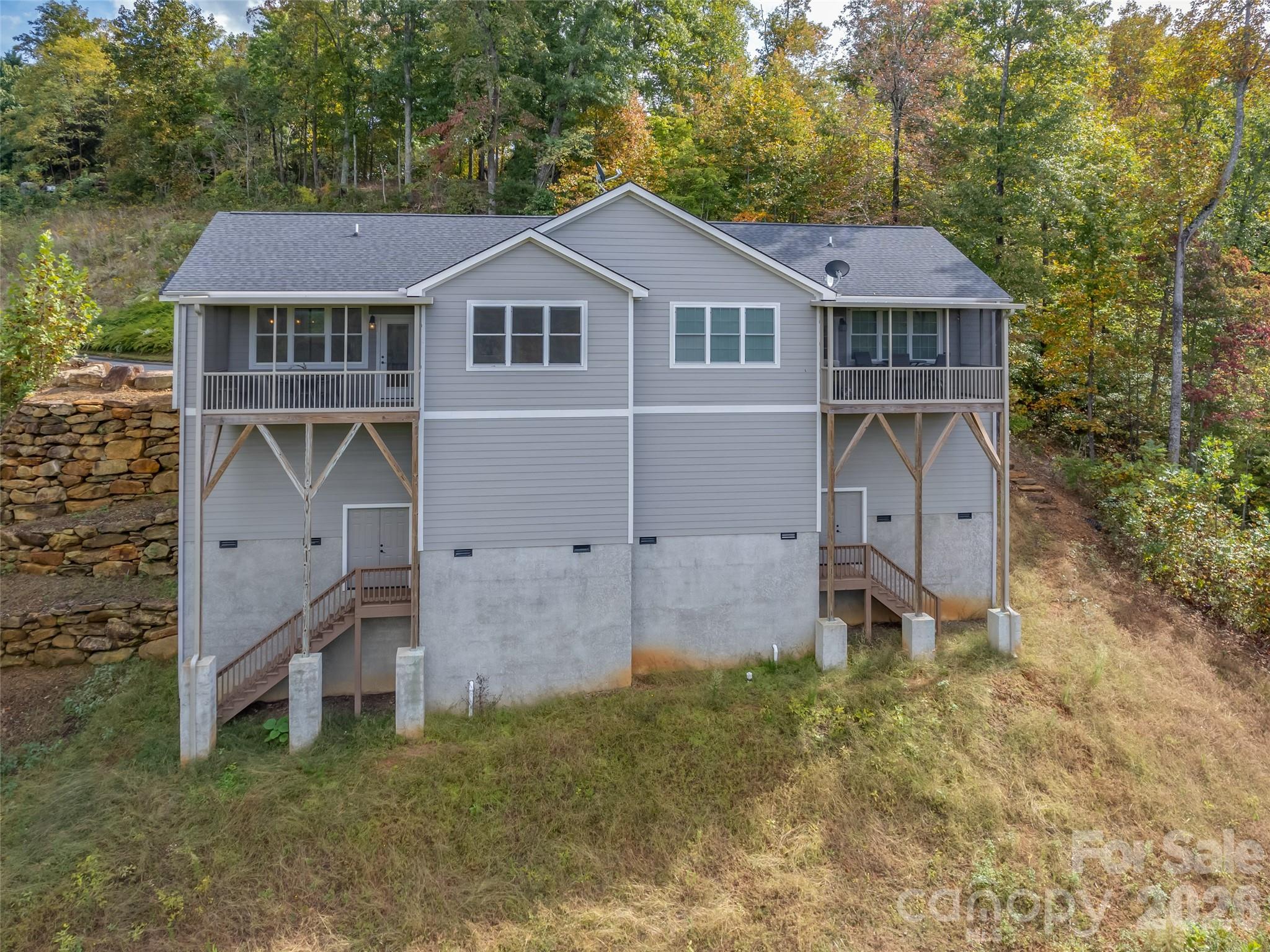 146 Red Hawk Knoll Lake Lure, NC 28746 - Photo 27 of 34 a aerial view of a house next to a yard and brick wall
