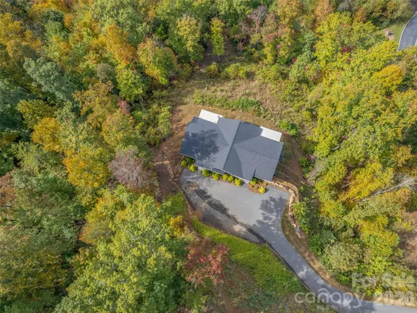 an aerial view of a house with yard swimming pool and outdoor seating