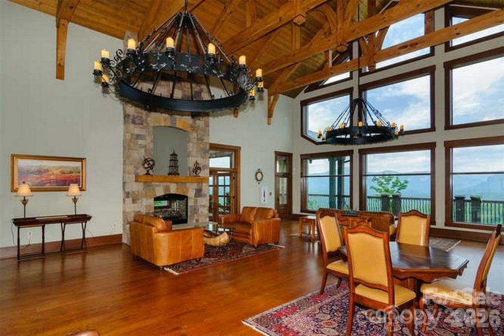146 Red Hawk Knoll Lake Lure, NC 28746 - Photo 32 of 34 a living room with furniture a fireplace and a chandelier