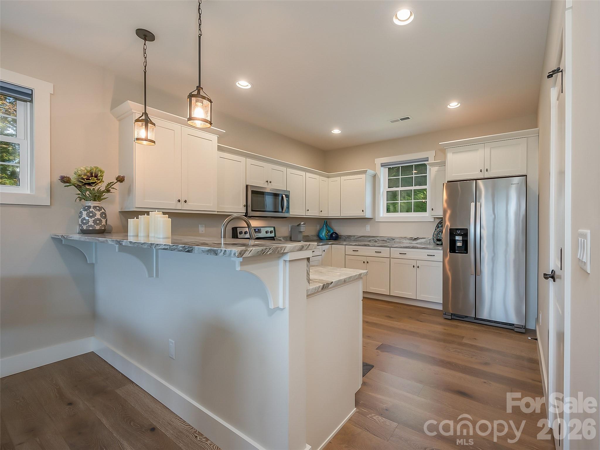 146 Red Hawk Knoll Lake Lure, NC 28746 - Photo 10 of 34 a kitchen with stainless steel appliances a refrigerator sink and cabinets