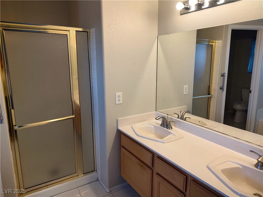 2223 Rugged Mesa Drive Laughlin, NV 89029 - Photo 16 of 28 Full bathroom with toilet, a stall shower, and a s