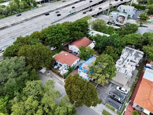 an aerial view of multiple houses with yard