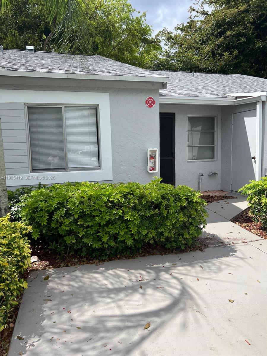 a view of a house with potted plants