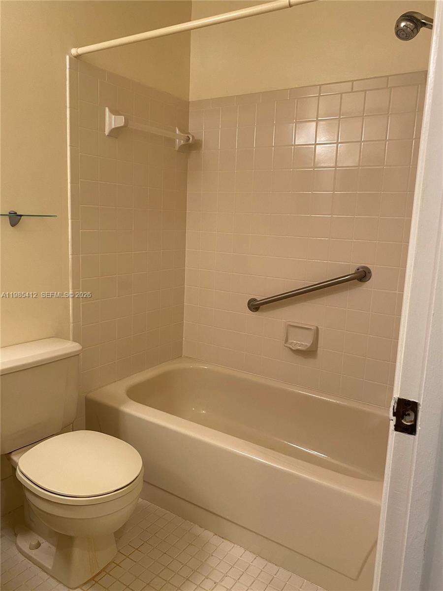 18595 Egret Way, Unit 18595 Boca Raton, FL 33496 - Photo 14 of 66 a bathroom with a toilet and shower