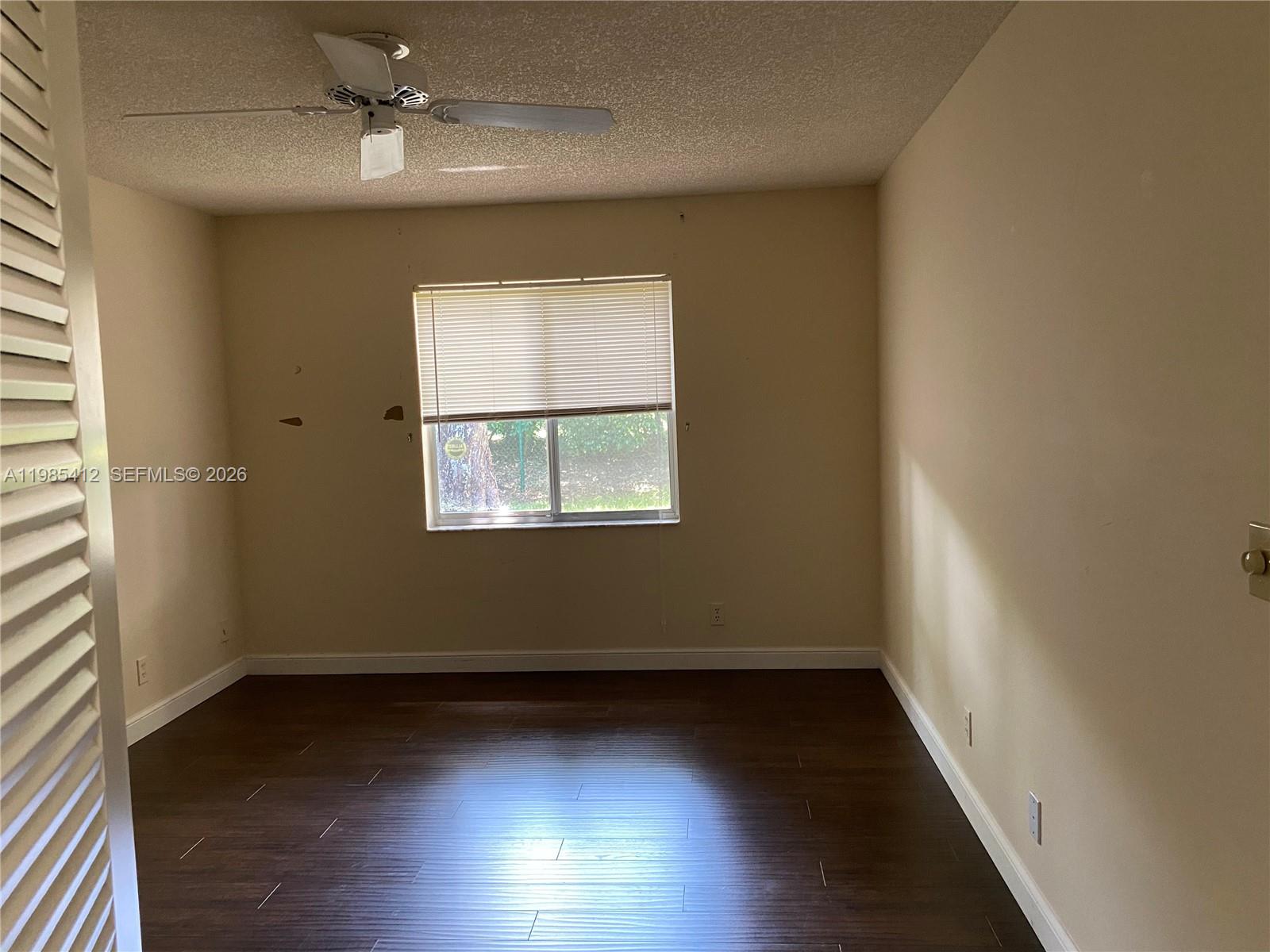 18595 Egret Way, Unit 18595 Boca Raton, FL 33496 - Photo 24 of 66 wooden floor in an empty room with a window