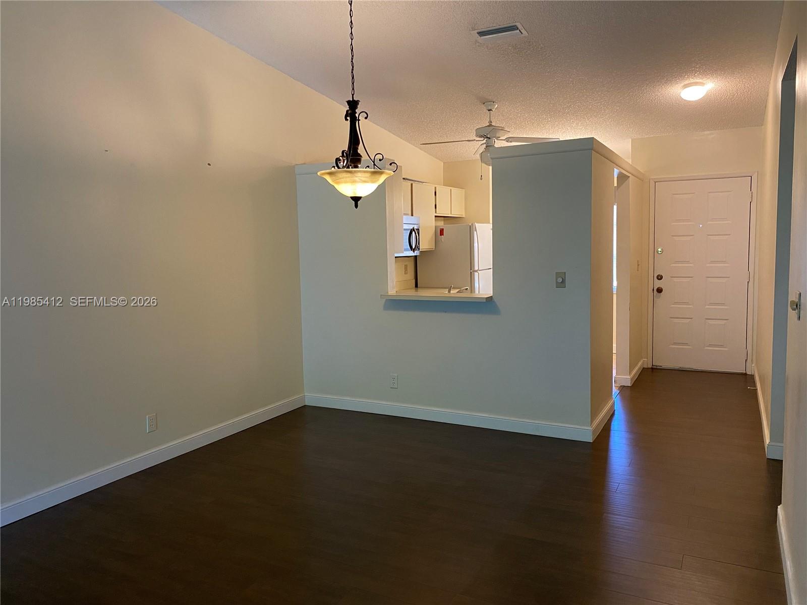 18595 Egret Way, Unit 18595 Boca Raton, FL 33496 - Photo 27 of 66 a view of empty room with wooden floor and ceiling fan