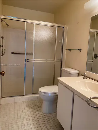 a kitchen with stainless steel appliances granite countertop a sink and a refrigerator