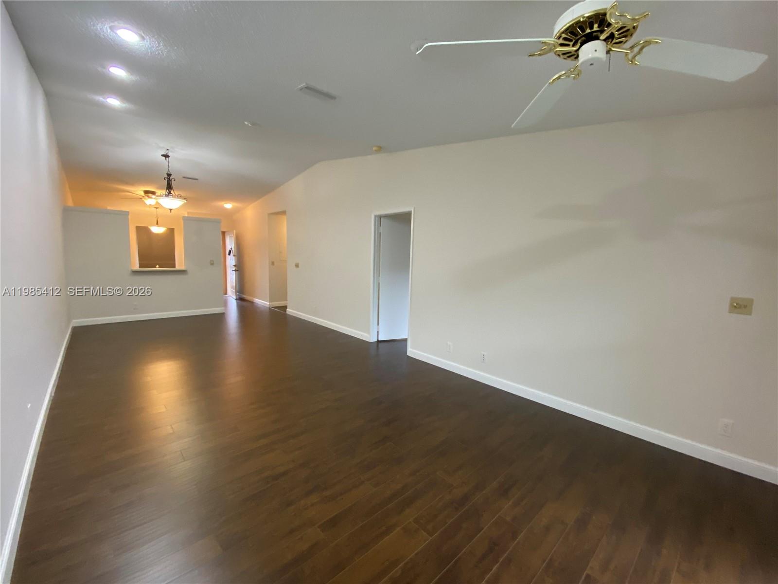 18595 Egret Way, Unit 18595 Boca Raton, FL 33496 - Photo 42 of 66 an empty room with wooden floor and windows