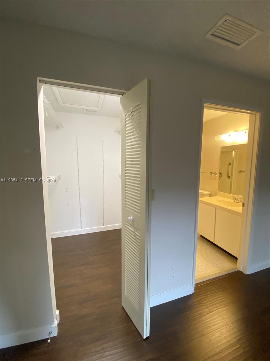 18595 Egret Way, Unit 18595 Boca Raton, FL 33496 - Photo 47 of 66 a view of an empty room with wooden floor and a window
