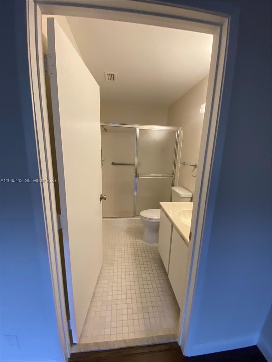 18595 Egret Way, Unit 18595 Boca Raton, FL 33496 - Photo 50 of 66 a view of a hallway with wooden floor and staircase