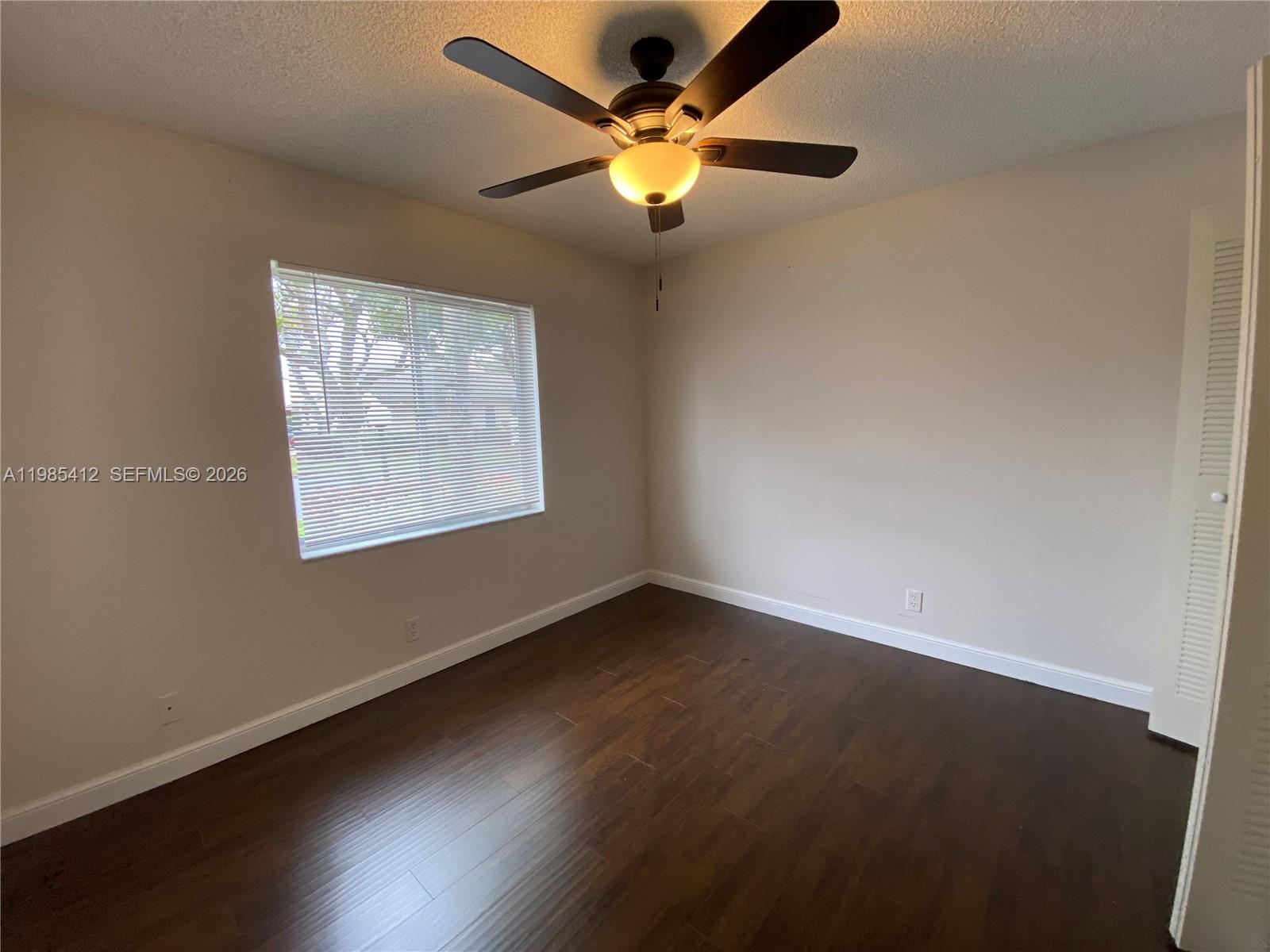 18595 Egret Way, Unit 18595 Boca Raton, FL 33496 - Photo 64 of 66 a view of an empty room with wooden floor