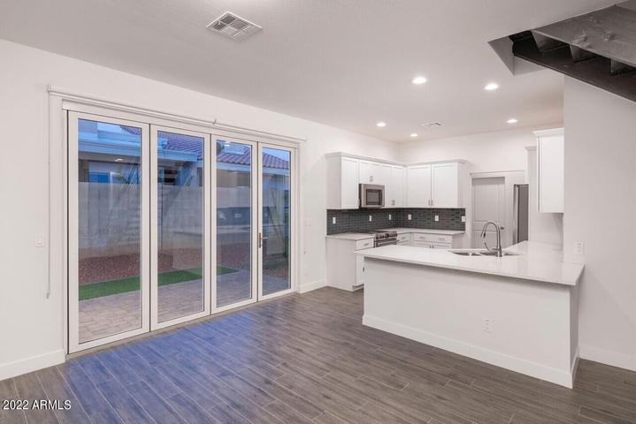 4210 North 28th Street, Unit 1 Phoenix, AZ 85016 - Photo 7 of 9 a kitchen with stainless steel appliances granite countertop a stove and a wooden floors