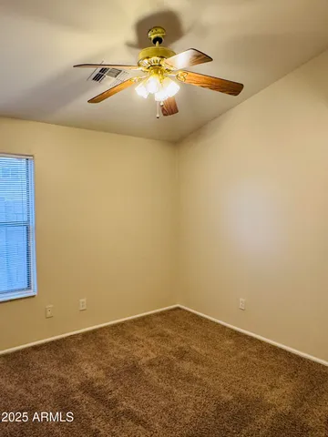 an empty room with a potted plant