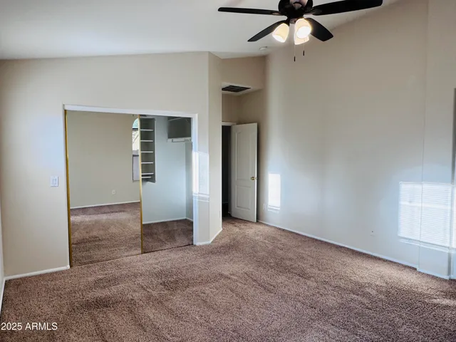 a view of a livingroom with a ceiling fan and window