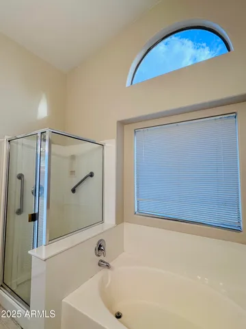 a bathroom with a bathtub and a shower
