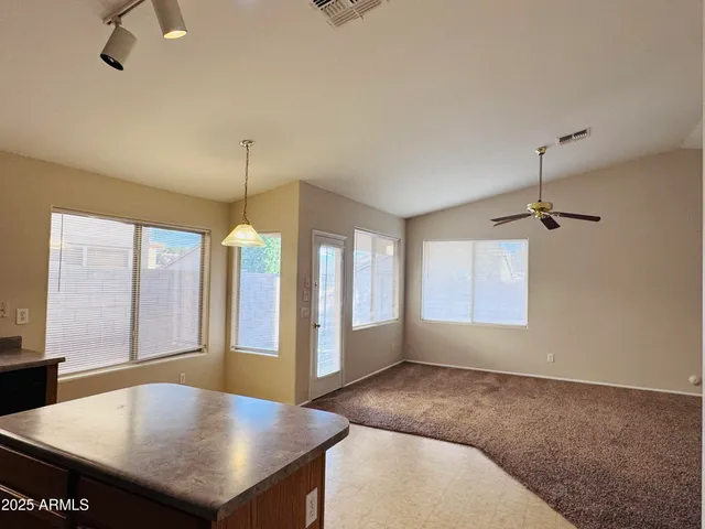 a living room with hardwood floor and a ceiling fan