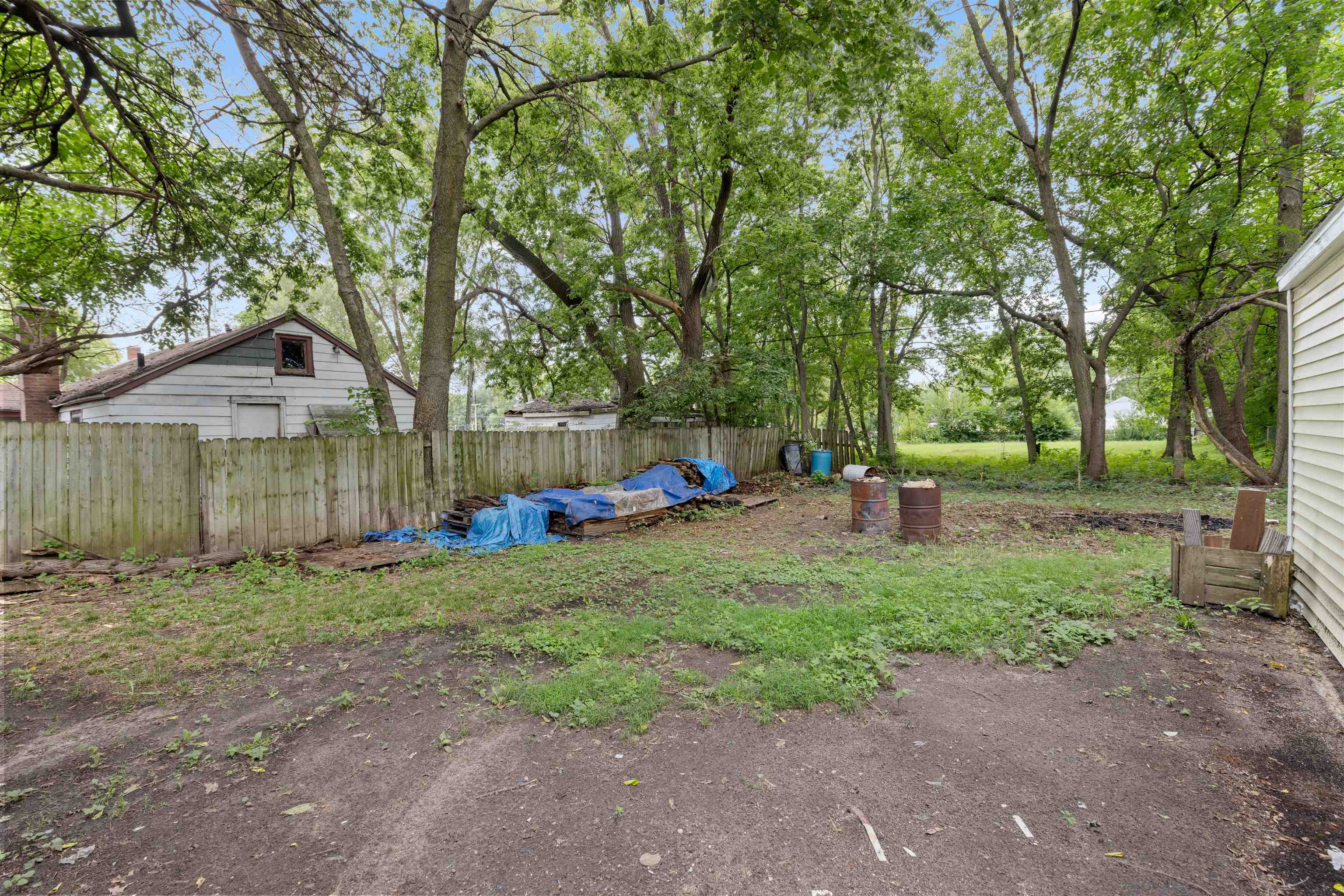 619 Fitch Road Rockford, IL 61109 - Photo 8 of 10 a view of a park with large trees and a wooden fence