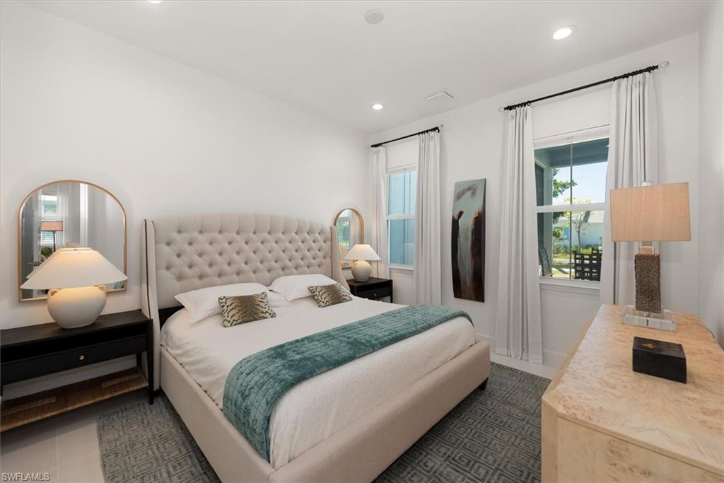 7315 Cayo Coco Lane Naples, FL 34113 - Photo 12 of 30 a bedroom with a bed and a lamp