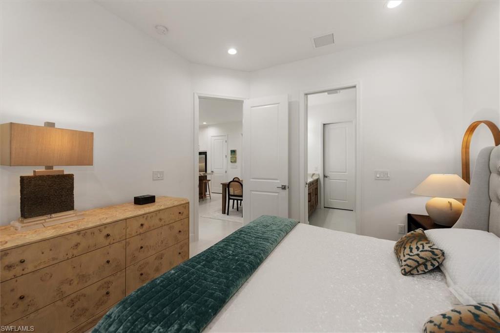 7315 Cayo Coco Lane Naples, FL 34113 - Photo 13 of 30 a bedroom with furniture and wooden floor