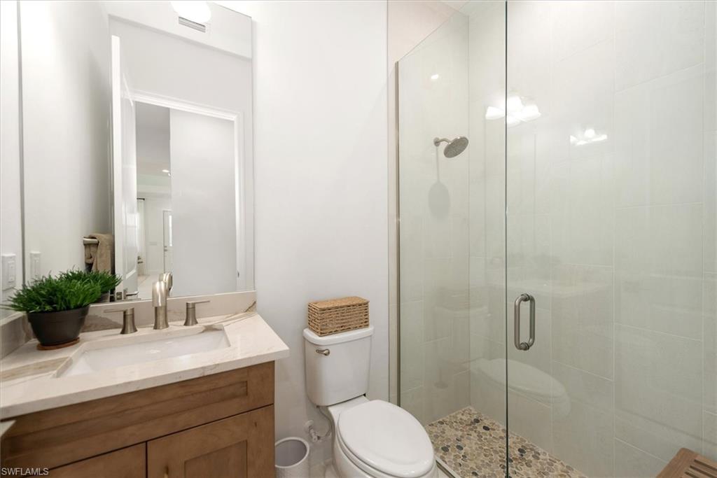 7315 Cayo Coco Lane Naples, FL 34113 - Photo 18 of 30 a bathroom with a sink a toilet and shower