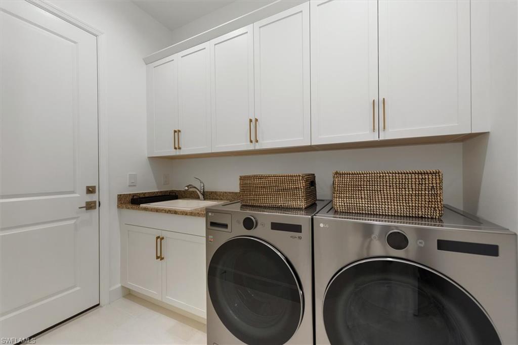 7315 Cayo Coco Lane Naples, FL 34113 - Photo 19 of 30 a utility room with dryer and washer