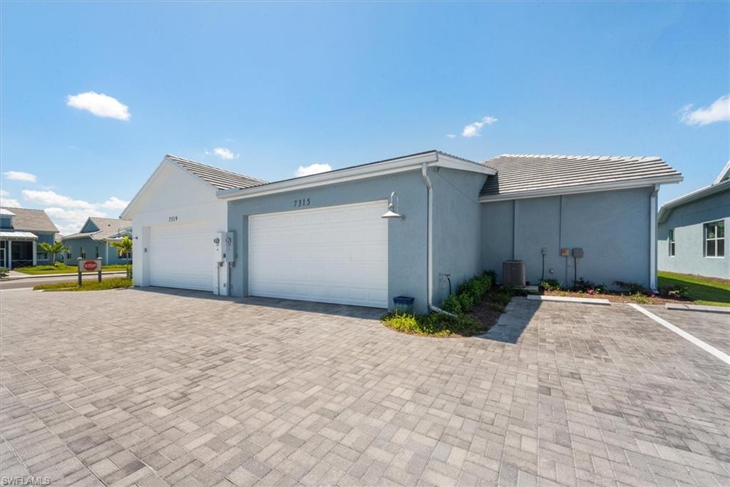 7315 Cayo Coco Lane Naples, FL 34113 - Photo 20 of 30 a view of a house with a yard and garage