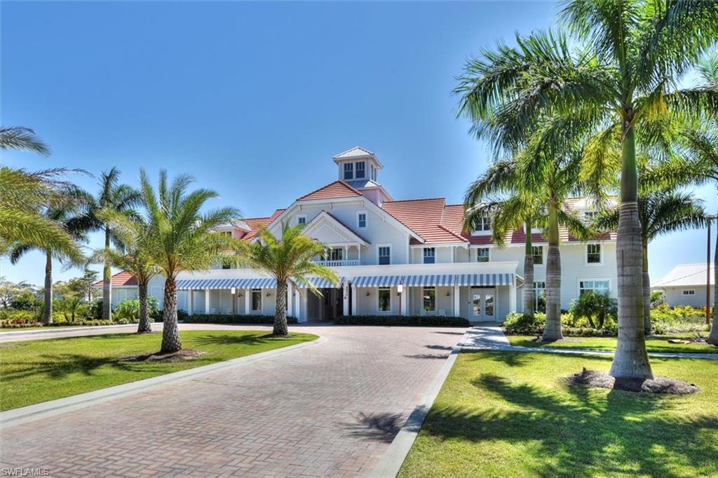 7315 Cayo Coco Lane Naples, FL 34113 - Photo 21 of 30 a front view of a house with swimming pool having outdoor seating