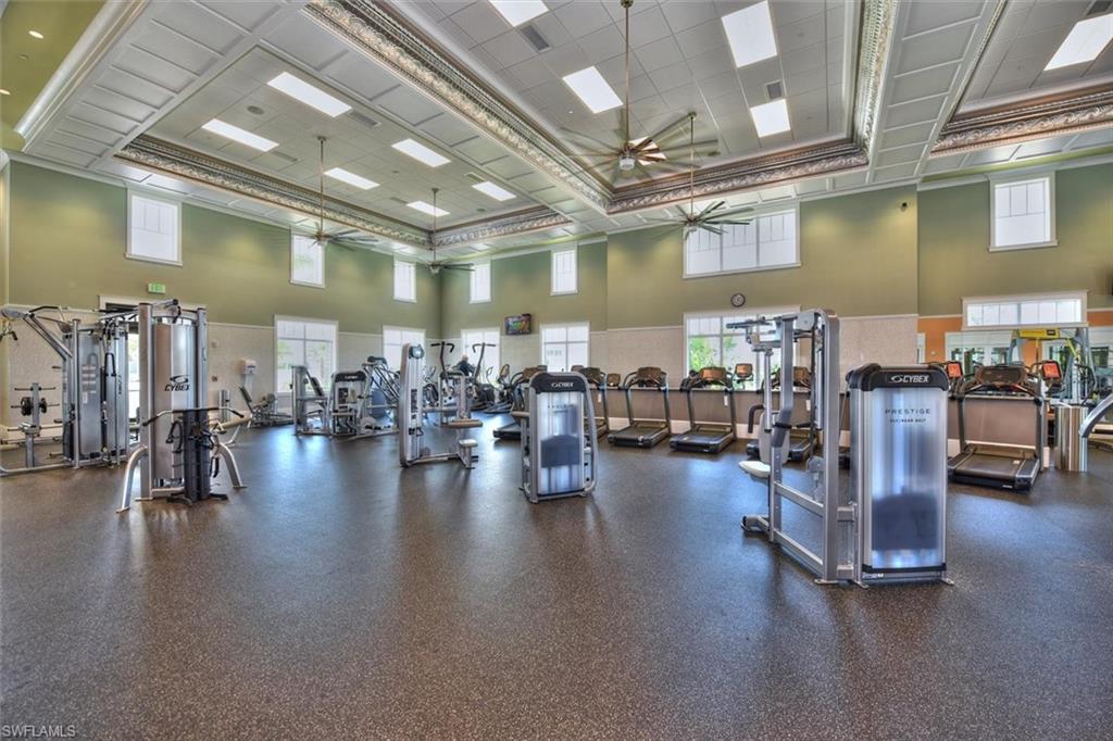 7315 Cayo Coco Lane Naples, FL 34113 - Photo 26 of 30 a gym room with lots of furniture and a large window