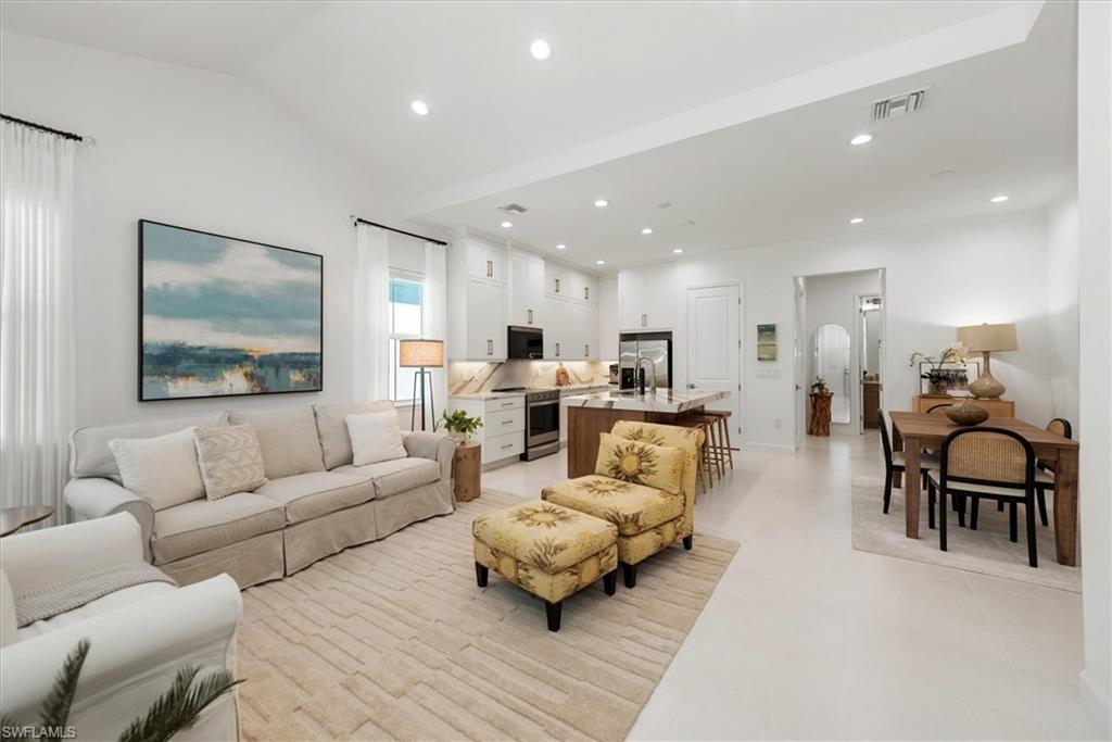 7315 Cayo Coco Lane Naples, FL 34113 - Photo 4 of 30 a living room with furniture and kitchen view