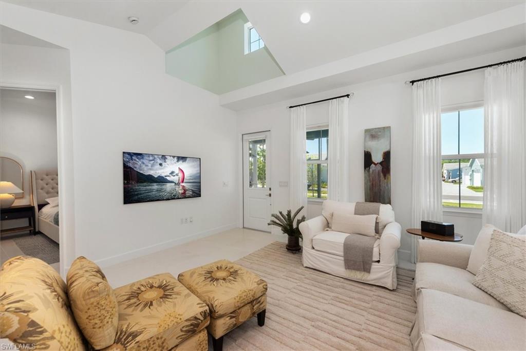7315 Cayo Coco Lane Naples, FL 34113 - Photo 7 of 30 a living room with furniture couches and a flat screen tv