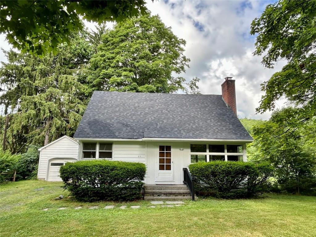 83 Cascade Road Amenia, NY 12501 - Photo 1 of 1 View of front of house with an outbuilding, a garage, and a front lawn