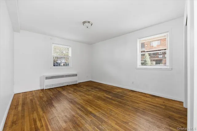 a view of a room with wooden floor and window