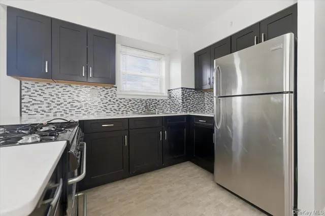 a kitchen with a refrigerator and a sink
